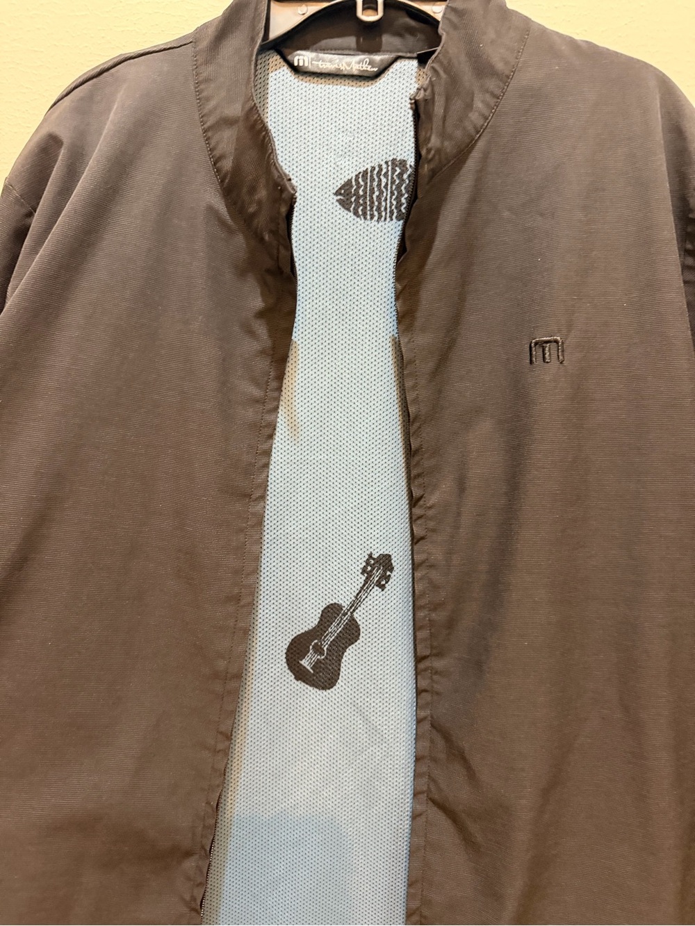 Travis Mathew light blue mesh jacket with Black Fish Graphic
